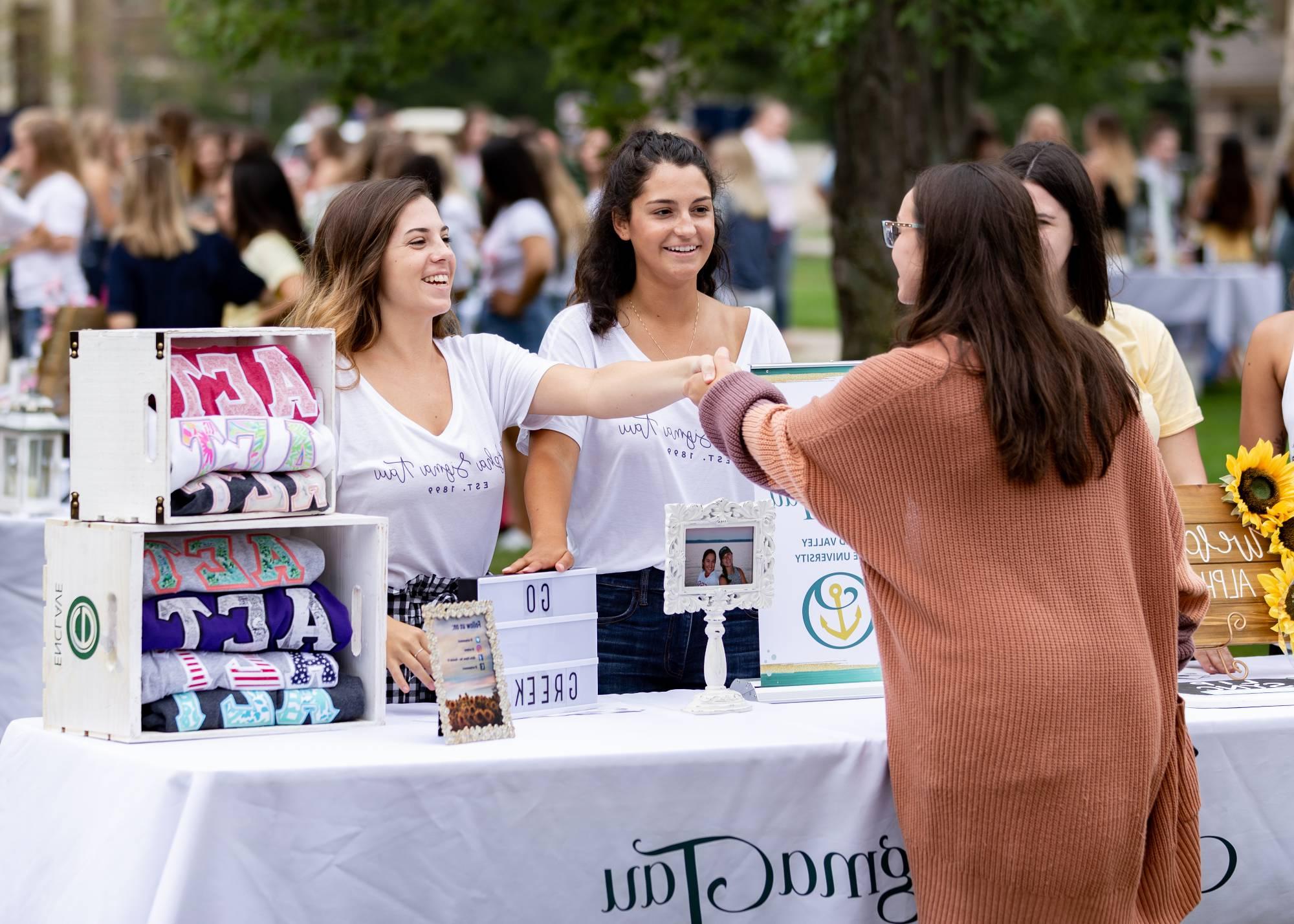 A student at a greek life information booth.